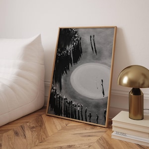 May include: A framed black and white photograph depicting an aerial view of a golf course. The image shows a circular sand bunker with a golfer standing inside, surrounded by a large crowd of spectators casting long shadows on the grass.
