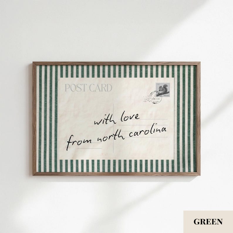 May include: A rectangular framed print featuring a vintage-style postcard design with dark green and white vertical stripes on the border. The postcard has the text POST CARD, a squirrel stamp, and the handwritten script with love from north carolina.