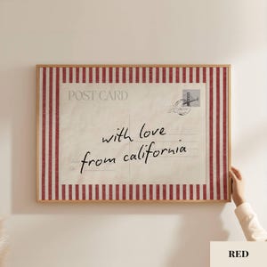 May include: A rectangular framed wall art piece featuring a vintage postcard design with a red and white vertical striped border. The center displays the text POST CARD, a stamp graphic, and the handwritten script with love from california.