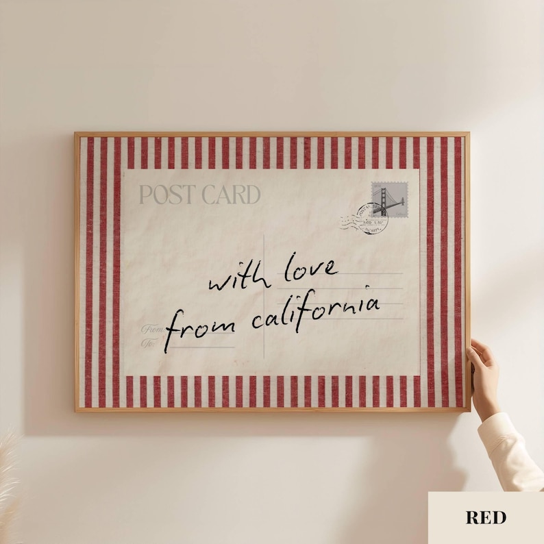 May include: A rectangular framed wall art piece featuring a vintage postcard design with a red and white vertical striped border. The center displays the text POST CARD, a stamp graphic, and the handwritten script with love from california.