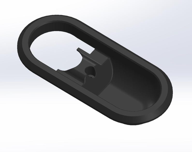 May include: Black plastic door handle with a rounded oval shape and a recessed area for a key.