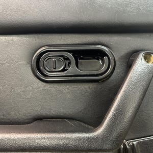 May include: Black plastic door handle with a black plastic latch and a black plastic pull handle.