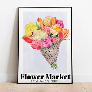 May include: A framed art print featuring a watercolor bouquet of tulips in shades of yellow, orange, and pink, presented in a dotted cone. The words "Flower Market" and "Botanical Collection" are printed at the bottom.