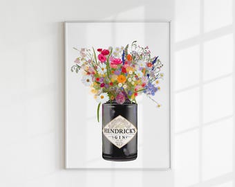 May include: A framed art print featuring a black Hendrick's Gin bottle used as a vase, filled with a vibrant, multi-coloured bouquet of wildflowers including daisies, poppies, and cornflowers. The label clearly displays the text Hendrick's Gin.