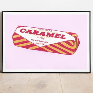 May include: A framed print of a Tunnock's Caramel Wafer biscuit. The wrapper is red and gold striped with the word "CARAMEL" in large red letters. The net weight is 30g.