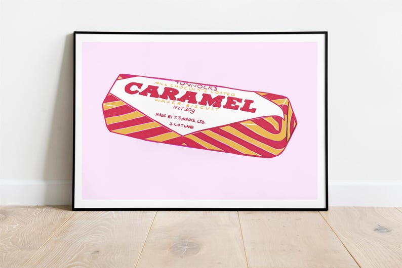 May include: A framed print of a Tunnock's Caramel Wafer biscuit. The wrapper is red and gold striped with the word "CARAMEL" in large red letters. The net weight is 30g.
