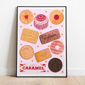 May include: A framed print featuring a collection of illustrated biscuits on a pink background. The biscuits include custard creams, bourbons, and digestives. The print also includes the text "CARAMEL".