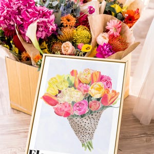 May include: A vibrant floral arrangement in a wooden box, alongside a framed print. The print features a watercolor bouquet of tulips and roses in a dotted cone, with the text "Flower Market, Botanical Collection".
