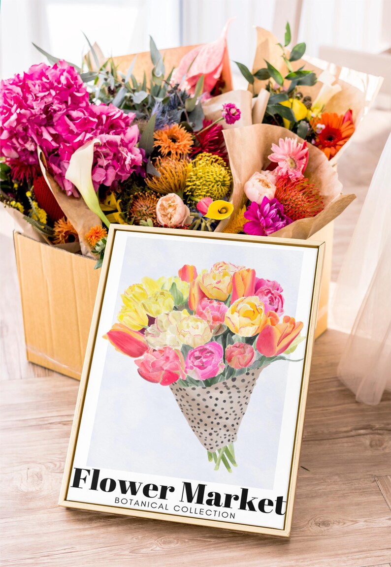 May include: A vibrant floral arrangement in a wooden box, alongside a framed print. The print features a watercolor bouquet of tulips and roses in a dotted cone, with the text "Flower Market, Botanical Collection".