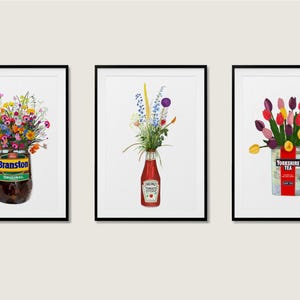 May include: Three framed art prints showcasing floral arrangements in repurposed containers. One print features wildflowers in a Branstons Original jar. Another has flowers in a Heinz ketchup bottle. The third print displays tulips in a Yorkshire Tea tin.