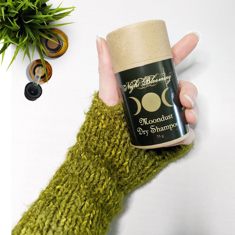 May include: A brown cardboard tube with a black label that says "Night Blooming" and "Moondust Dry Shampoo" with a crescent moon graphic. The tube is 75g.