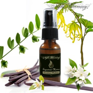 May include: A brown glass bottle with a black spray nozzle filled with a clear liquid. The bottle is labeled "Night Blooming Signature Mister Custom Mister 1 oz". The bottle is surrounded by vanilla beans, white flowers, and green leaves.
