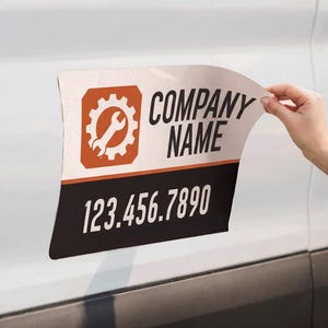 May include: A rectangular vehicle magnet featuring a white background with an orange square icon containing a white gear and wrench graphic. The text COMPANY NAME appears in black, and the number 123.456.7890 is printed in white on a black bar.