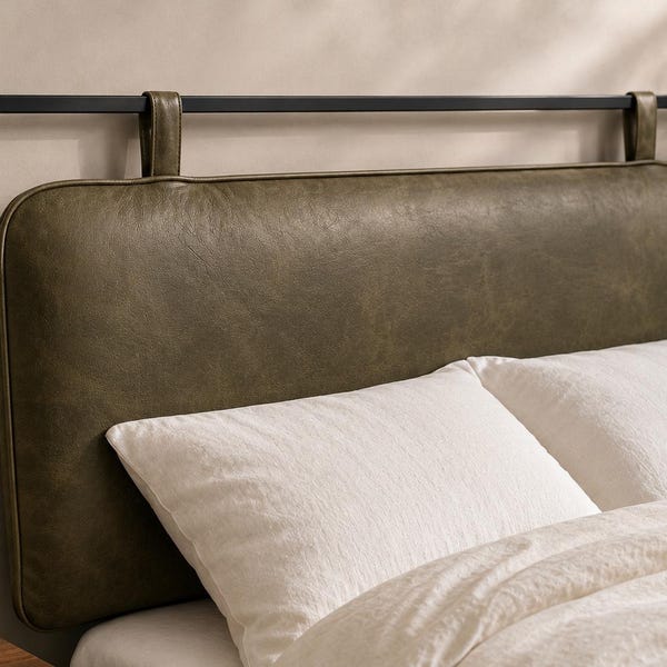 May include: A rectangular olive green headboard with rounded corners, suspended from a horizontal black metal rod by two matching olive green straps. The headboard features a smooth, matte finish and is positioned behind two white pillows.