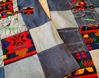 May include: Patchwork denim fabric with sections of light and dark blue denim, and colorful patterned fabric. The design incorporates pockets and straps from jeans. The overall design is a quilt or textile with a unique, handcrafted aesthetic.