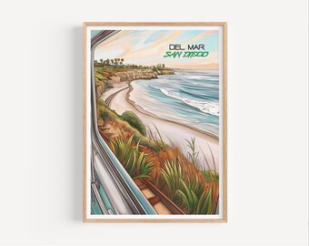 May include: A framed art print showing a coastal view from Del Mar, San Diego. The artwork presents a beach with ocean waves, cliffs, and a railway track, seen through a train window. The text "DEL MAR SAN DIEGO" is displayed in green.