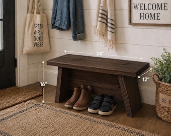 May include: A dark brown wooden bench, 24 inches long, 16 inches high, and 12 inches deep, with shoes underneath. A tote bag with "FRESH AIR & GOOD VIBES" hangs nearby. A sign says "WELCOME HOME". A basket with a plant and a "BE KIND" tag is also present.