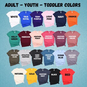 May include: A chart of t-shirt colors with the words "Adult - Youth - Toddler Colors" at the top. The colors include white, true royal, team purple, light pink, navy, orange, kelly green, maroon, heather peach, heather raspberry, heather maroon, heather mauve, heather olive, athletic heather, dark grey heather, heather deep teal, ocean blue, heather storm, natural, gold, heather navy, black, and red.