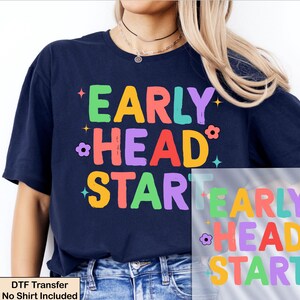 May include: Navy blue t-shirt with the words "EARLY HEAD START" in colorful, playful letters. The design includes stars and flower accents. A DTF transfer is also visible.