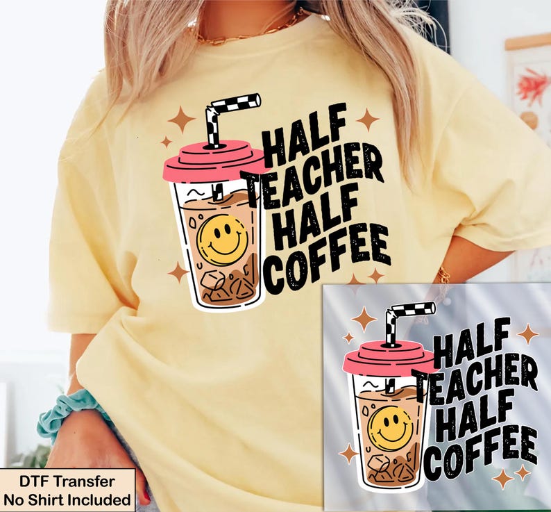 May include: A pale yellow t-shirt featuring a graphic of an iced coffee cup with a pink lid, a black and white checkered straw, and a yellow smiley face. The text reads HALF TEACHER HALF COFFEE in bold black letters, surrounded by small brown stars.