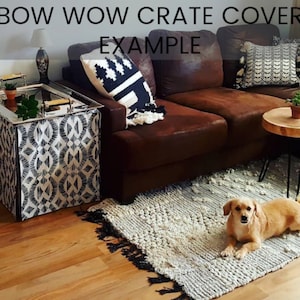May include: A black and white patterned crate cover with the text "BOW WOW CRATE COVER EXAMPLE" on a brown leather couch with a small dog sitting on a white rug.