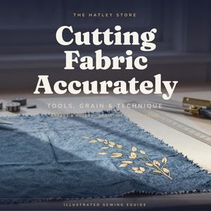 May include: A blue fabric square with a gold leaf print, metal sewing shears, and a long metal ruler. The text reads: THE HATLEY STORE, Cutting Fabric Accurately, TOOLS, GRAIN & TECHNIQUE, SHEARS & ROTARY, GRAINLINE, ILLUSTRATED SEWING EGUIDE.