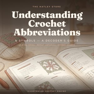 May include: An illustrated guide titled Understanding Crochet Abbreviations & Symbols - A Decoder's Guide by The Hatley Store. The book features crochet diagrams, a ball of yarn with a square motif, and a wooden crochet hook on a flat surface.