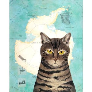 May include: A watercolor painting of a tabby cat with yellow eyes, set against a backdrop of a vintage map of Antarctica. The map features the Antarctic Circle, Indian Ocean, and other geographical details.