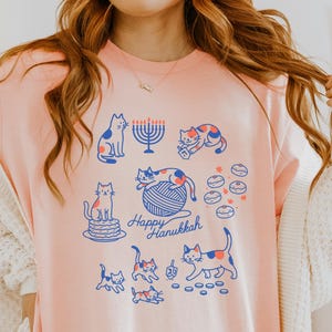 Cozy Hanukkah Cat Shirt - Jewish Cat Mom Graphic Tee with Menorah & Dreidel