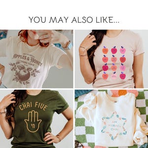 May include: A collection of t-shirts and a sweatshirt with various designs. One shirt is cream-colored with the text "Apples & Honey" and an apple graphic. Another is olive green with "Chai Five" and a hand graphic. A third shirt is tan with apple graphics and text. The sweatshirt is cream-colored with a Star of David graphic.
