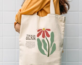 May include: Cream-colored tote bag with a floral design and text. The design features a red flower with a yellow center, green leaves, and the words "TIKKUN OLAM". The bag has a cream-colored strap.