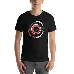 May include: A black t-shirt featuring a white and red graphic design of a circular target with a red centre and white rings.