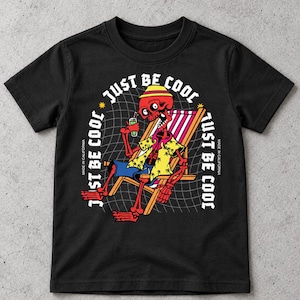 May include: A black short-sleeve t-shirt featuring a graphic of a red skeleton wearing a yellow hat and shirt, sitting in a striped beach chair while holding a green drink. The text JUST BE COOL is printed in white around the graphic.