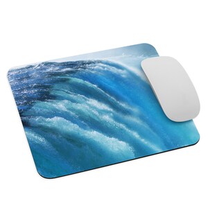 May include: A blue and white mouse pad with a photo of a waterfall. The mouse pad is made of a soft, durable material and is perfect for use with a computer mouse.