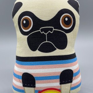 May include: A stuffed pug dog toy with a cream-colored body and black accents. The pug is wearing a shirt with horizontal stripes in blue, pink, and white. A rainbow is at the bottom of the shirt.
