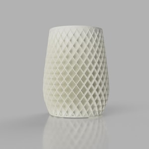 May include: A cylindrical white vase featuring a repeating diamond-shaped lattice pattern across its entire exterior surface. The structure is composed of interconnected geometric struts, creating an open, airy design with a solid base and rim.