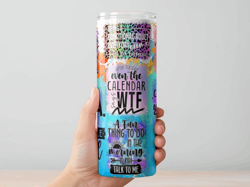 May include: A tall, cylindrical tumbler with a colorful design and humorous text. The tumbler features a mix of watercolor-style splashes in orange, purple, and blue. Text includes phrases like "Being a functional adult" and "WTF".