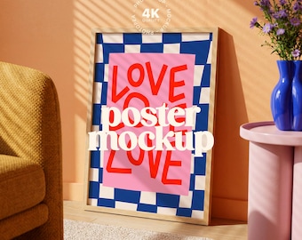 May include: A framed poster mockup with the word "LOVE" in red, "poster mockup" in white, and "LOVE" in red again. The poster has a pink background with a blue and white checkered pattern. The frame is light brown.