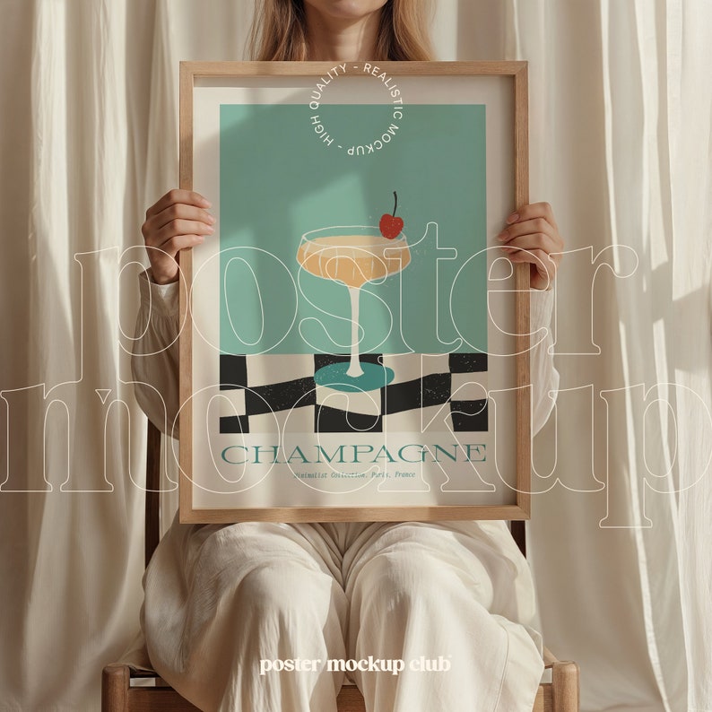 May include: A woman holds a framed poster with a retro design featuring a glass of champagne with a cherry on top. The poster has a blue and green color scheme with a black and white checkered pattern at the bottom. The text on the poster reads "Champagne" and "Vinicult. Brilliante. Paris, France".