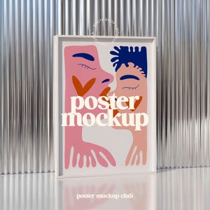 May include: A white framed poster mockup featuring a colourful illustration of two people kissing. The poster has the text "poster mockup" in white lettering.