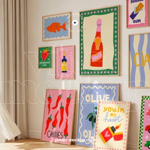 May include: A collection of framed art prints with colorful illustrations. The prints feature a fish, a strawberry, a bottle, a champagne bottle, chili peppers, olives, a lighter, and the words "Bubble Gum" and "Ciao".