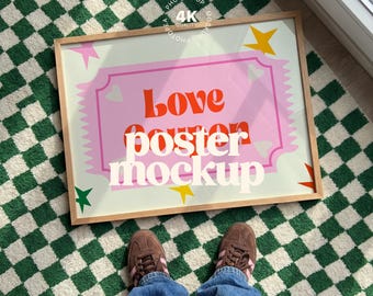 May include: A framed poster mockup with the words "Love Poster Mockup" in a playful font. The poster has a pink background with a decorative border and star accents. The frame is light wood, and the poster is on a green and white checkered rug.