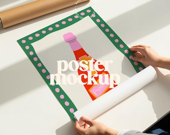 May include: A poster mockup featuring a colorful illustration of a champagne bottle with the word "Prosecco" on it. The poster is framed with a green border with pink polka dots. A rolled-up poster and a cardboard tube are also visible.