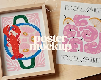 May include: Two framed posters with colorful illustrations. The poster on the left features a red lobster in a blue bowl with pink flowers. The poster on the right features pink shrimp with the text "FOOD MARKET" in black.