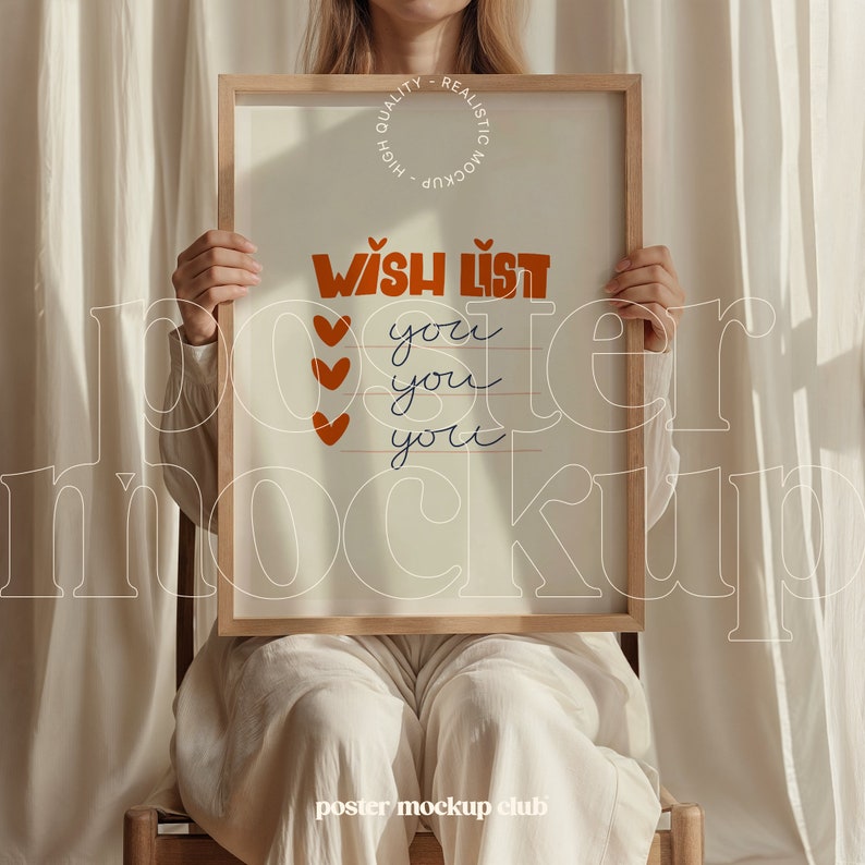 May include: A wooden framed poster mockup with a white background and the text "WISH LIST" in orange and brown lettering. The text "you" is repeated four times in black lettering below the title. The poster is being held by a person wearing white pants.