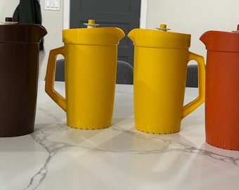 Vintage Tupperware 2 Quart Pitchers with push button lids. Brown 800-11, Yellow 800-8, Tan 800-9, Orange 800-8, Clear 1676-2. Good used cond