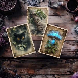 May include: Three vintage-style art prints on a wooden surface. One features a black cat with glowing eyes, another a tree trunk with Celtic knot designs, and the third a glowing blue mushroom. The prints have aged paper edges.
