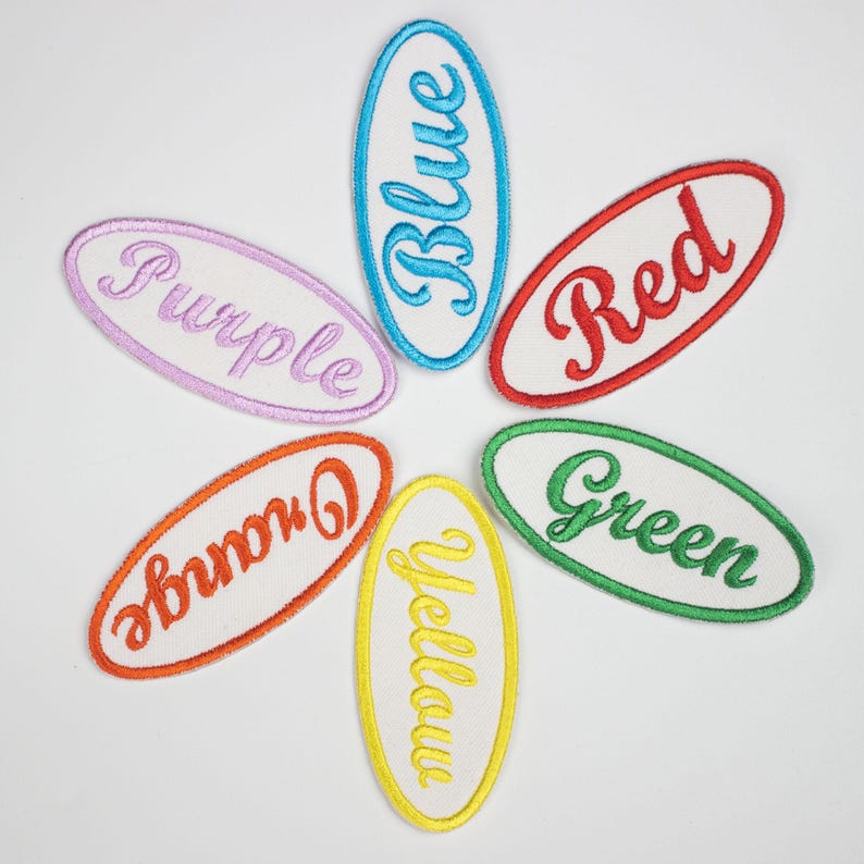 May include: Six oval-shaped embroidered patches in different colors, each with a different color word: blue, purple, red, orange, yellow, and green.