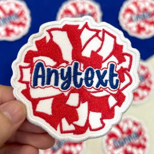 May include: Embroidered patch with a red and white design, featuring the text "Anytext" in blue script. The patch has a white border and is set against a blue background. Several similar patches are visible.