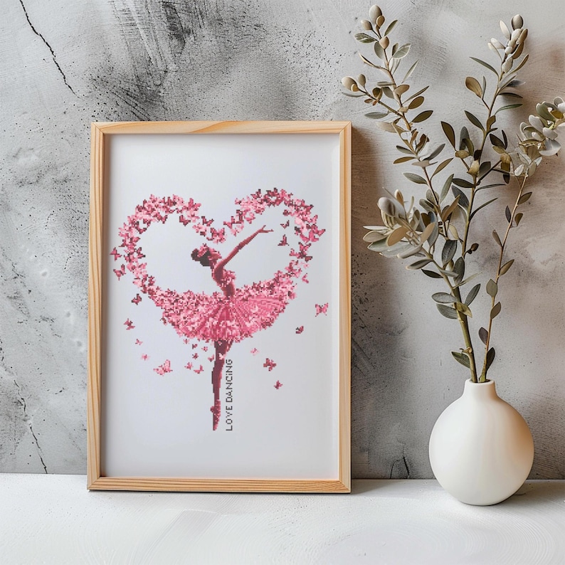May include: A framed print of a ballerina dancing in a pink tutu, surrounded by pink butterflies in the shape of a heart. The print has the text "LOVE DANCING" at the bottom.